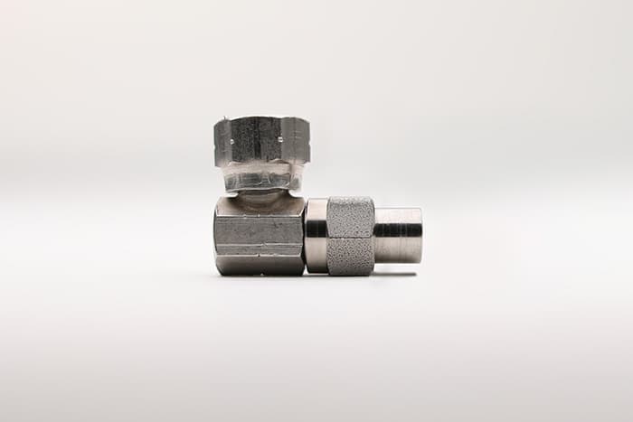 A single 90 degree paint hose fitting without a spring guard