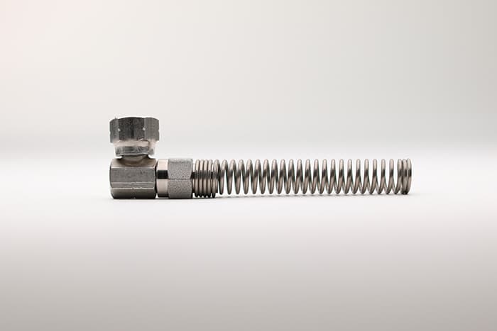 A single 90 degree paint hose fitting with a spring guard